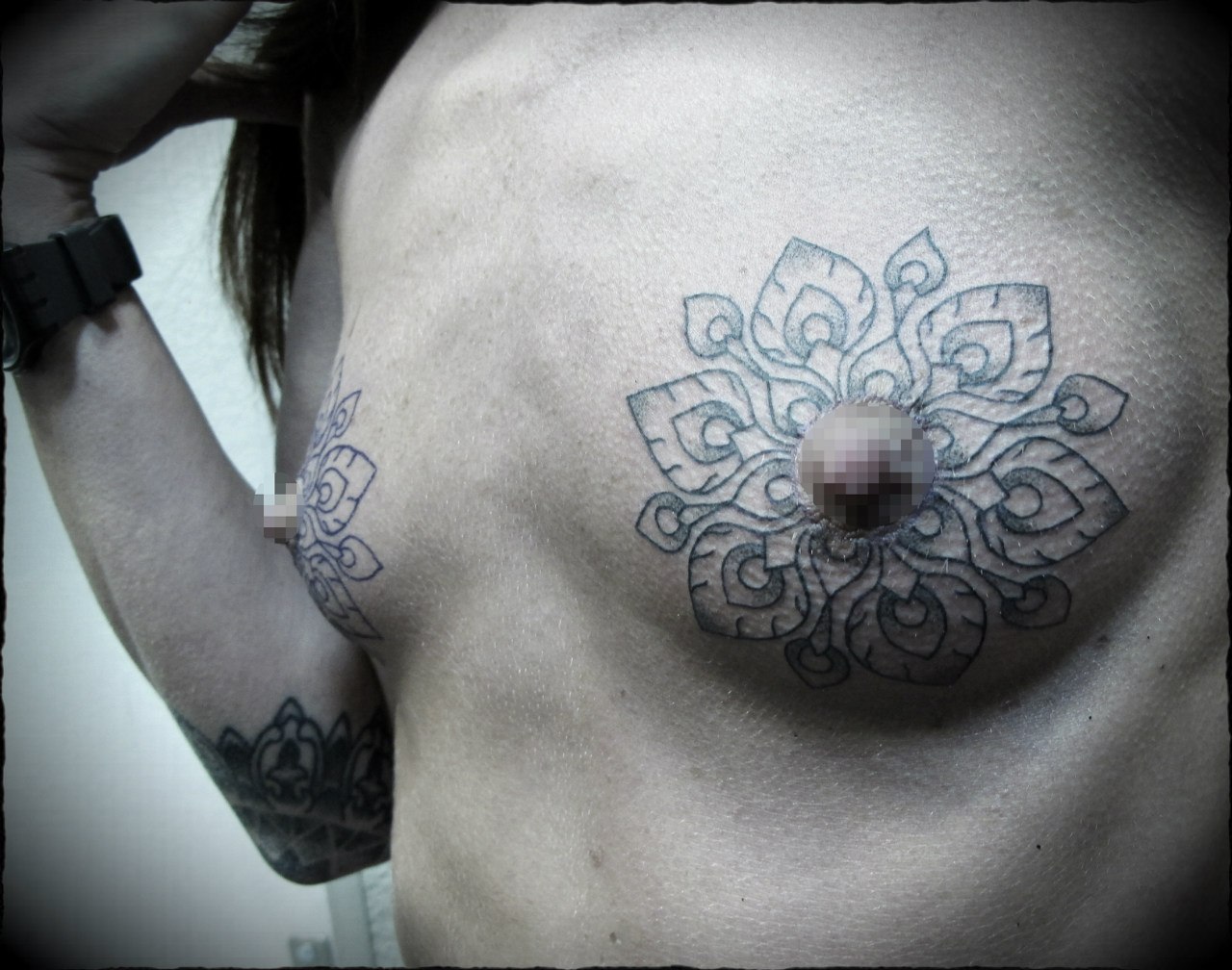 Small nipple tattoo